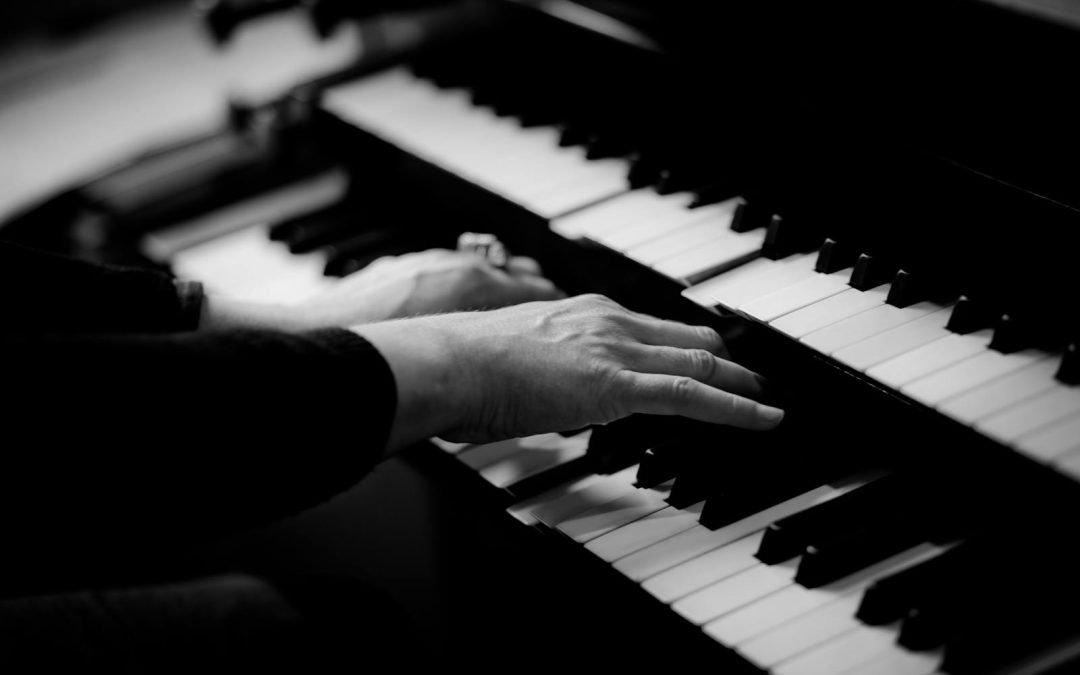 Close-up of hands playing piano keys, capturing the essence of musical creativity.