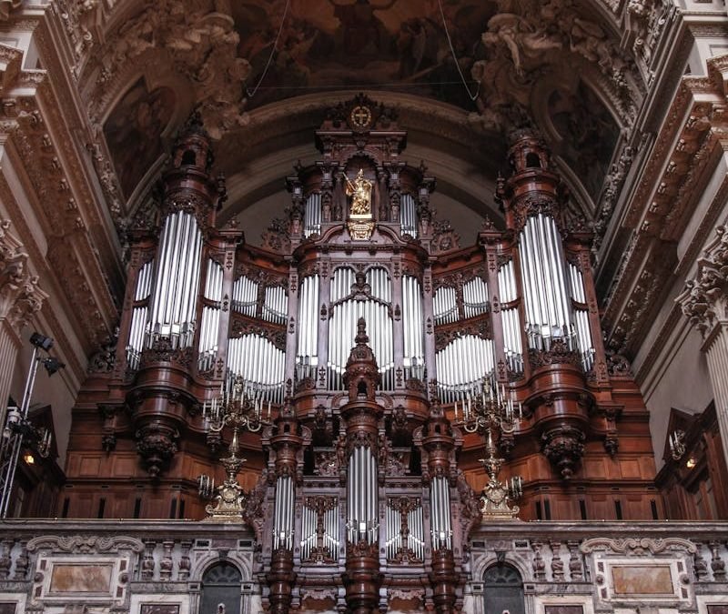 Stunning view of an ornate organ inside a historic cathedral, showcasing intricate architectural details.