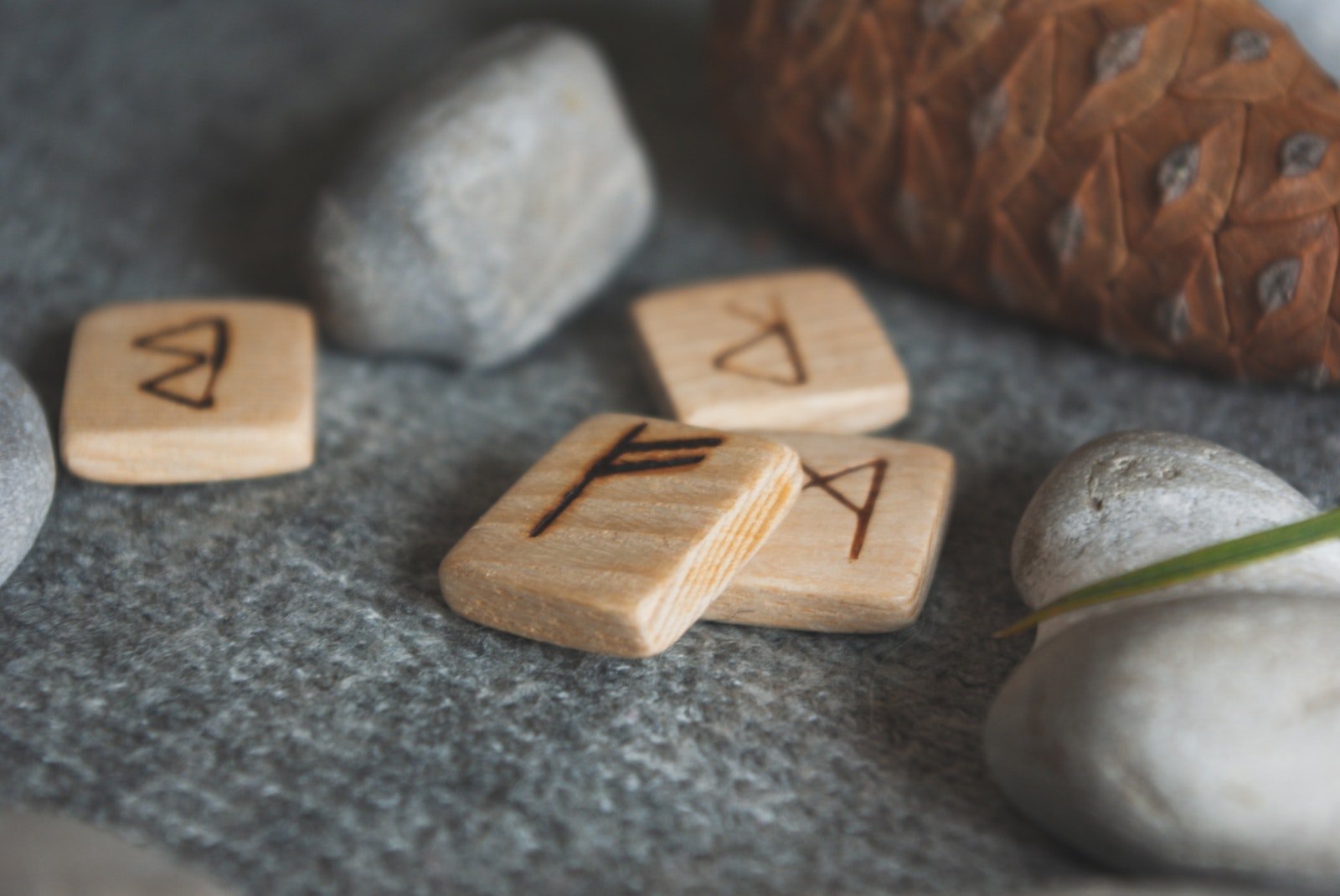 Wooden runes and stones scattered on wool plaid