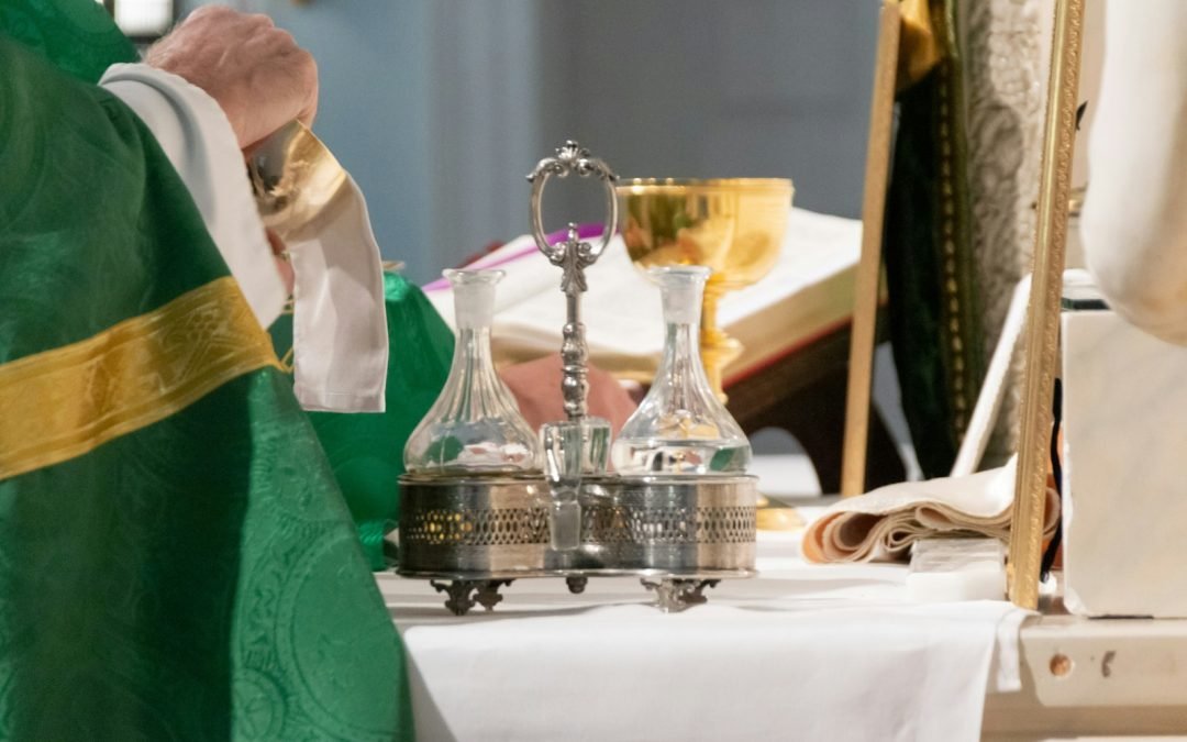 priest wiping chalice